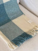 Pure NZ wool throw in cream and blue check plaid, by Exquisite Wool Traders, folded 
