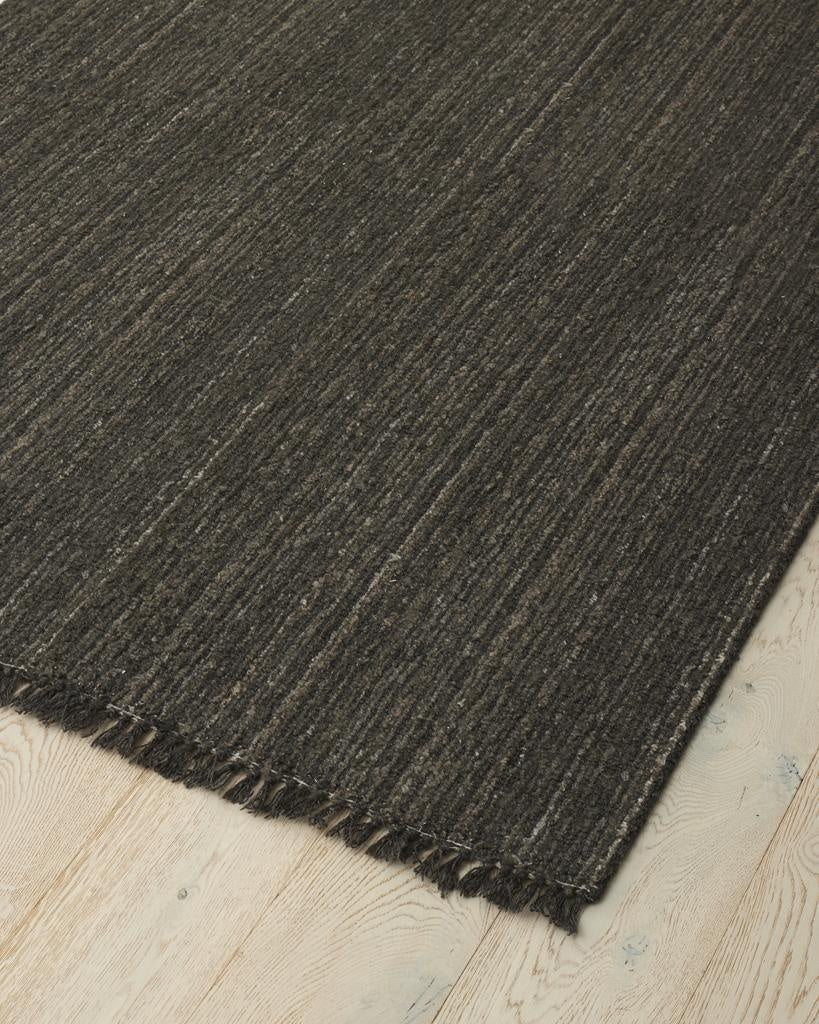 The 'Puglia' floor rug by Weave Home, in colour 'Pigeon" - a deep cool-toned brown, sitting on floor 