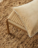 A modern floor rug by Weave Home nz, in shades of brown, with a boucle weave shown  from above with cushion and stool props