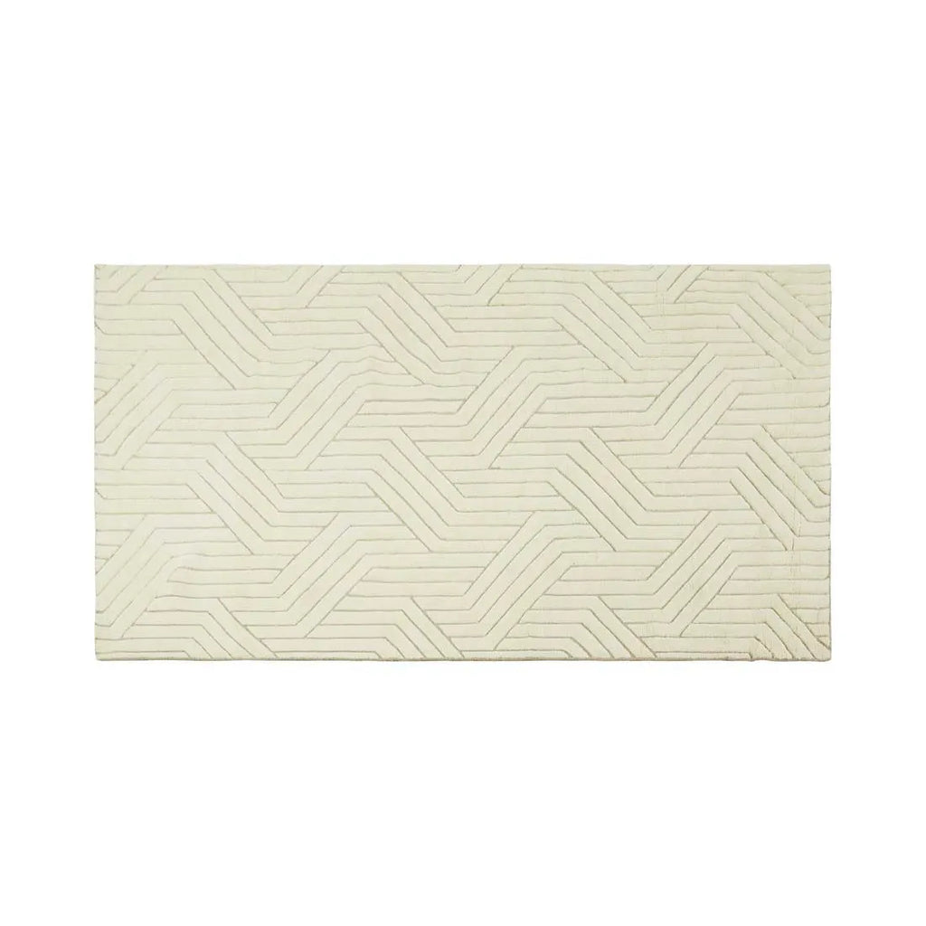 Full view of a cream/ivory wool floor rug featuring a striking geometric design