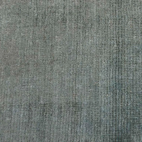 An ocean green contemporary floor rug in a wool blend