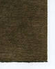 A corner image of a 100% wool moss green floor runner with a small fringed edge.