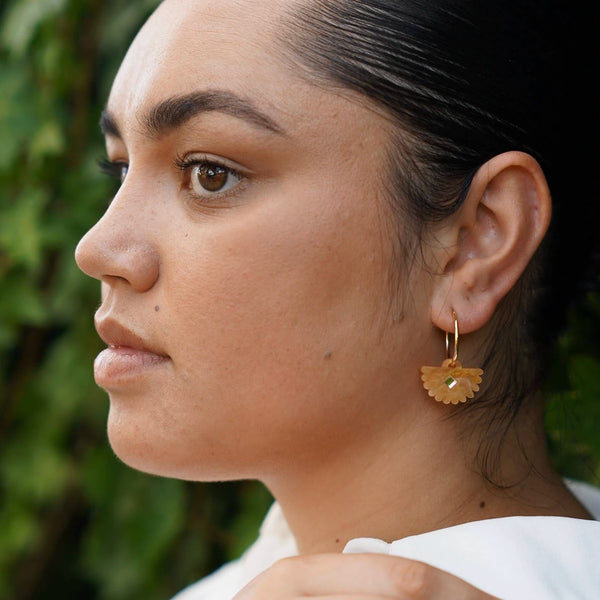 Brown chestnut coloured fantail earrings worn by a model