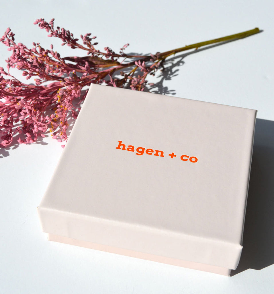 A stylish pale pink gift box that Hagen _ Co earrings are presented in