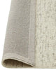 Wool boucle floor rug 'Henley Pelican' by Weave Home nz, rolled to reveal underneath
