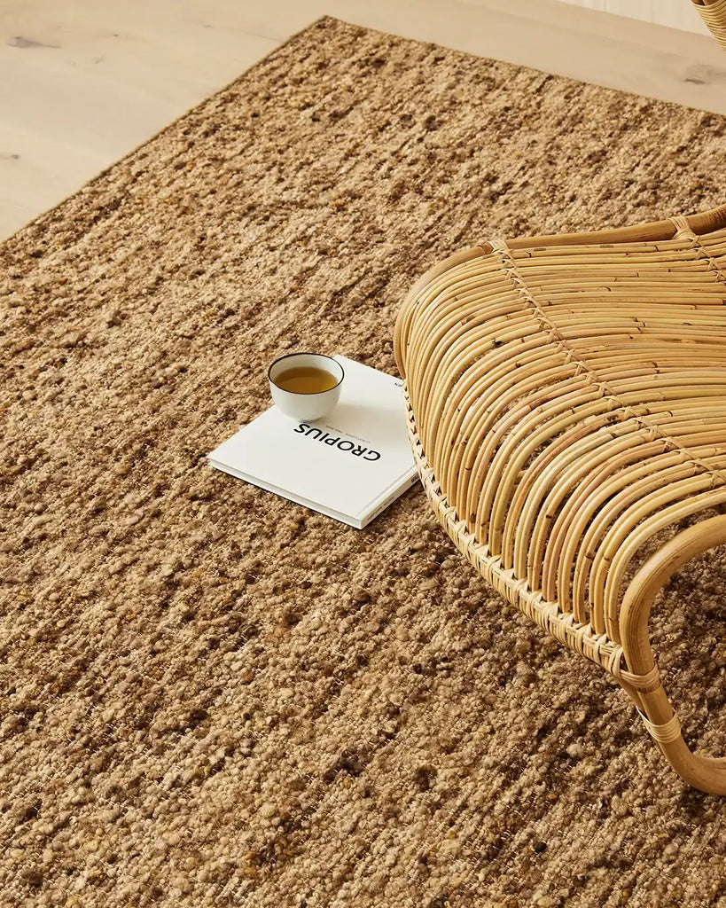 A modern floor rug by Weave Home nz, in shades of brown, with a boucle weave