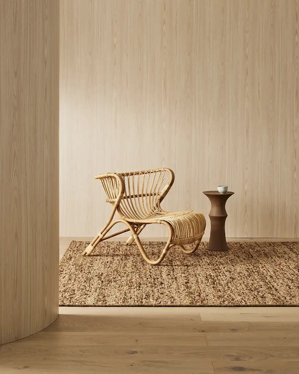 A modern floor rug by Weave Home nz, in shades of brown, styled in a contemporary home