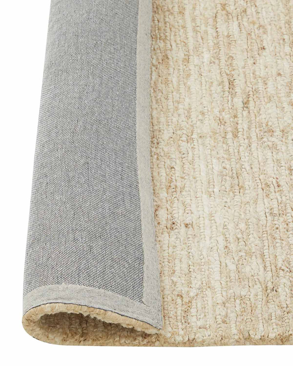 A corner image of a white floor rug in textural jute fibres with the edge rolled up to show the durable jute backing. 