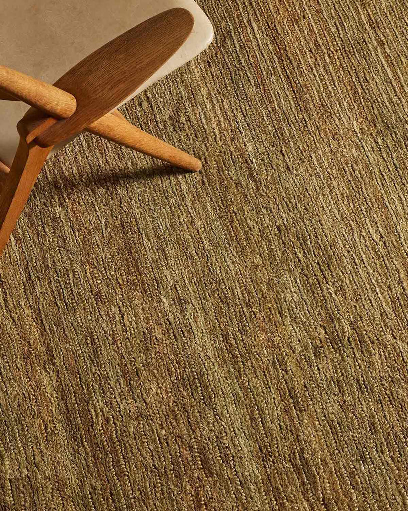 A textural floor rug in 100% jute in an on-trend warm green tone with handwoven cut-loop piling. 