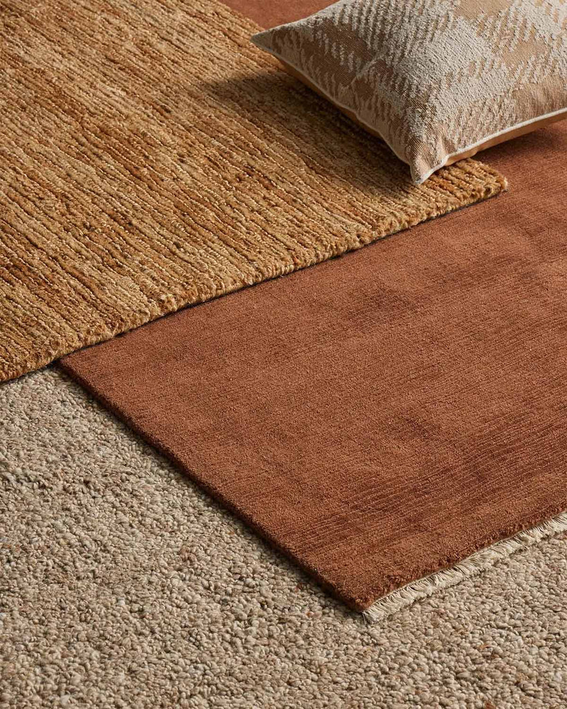 A number of floor rugs from Weave Home in complimentary shades of brown with different textures. 