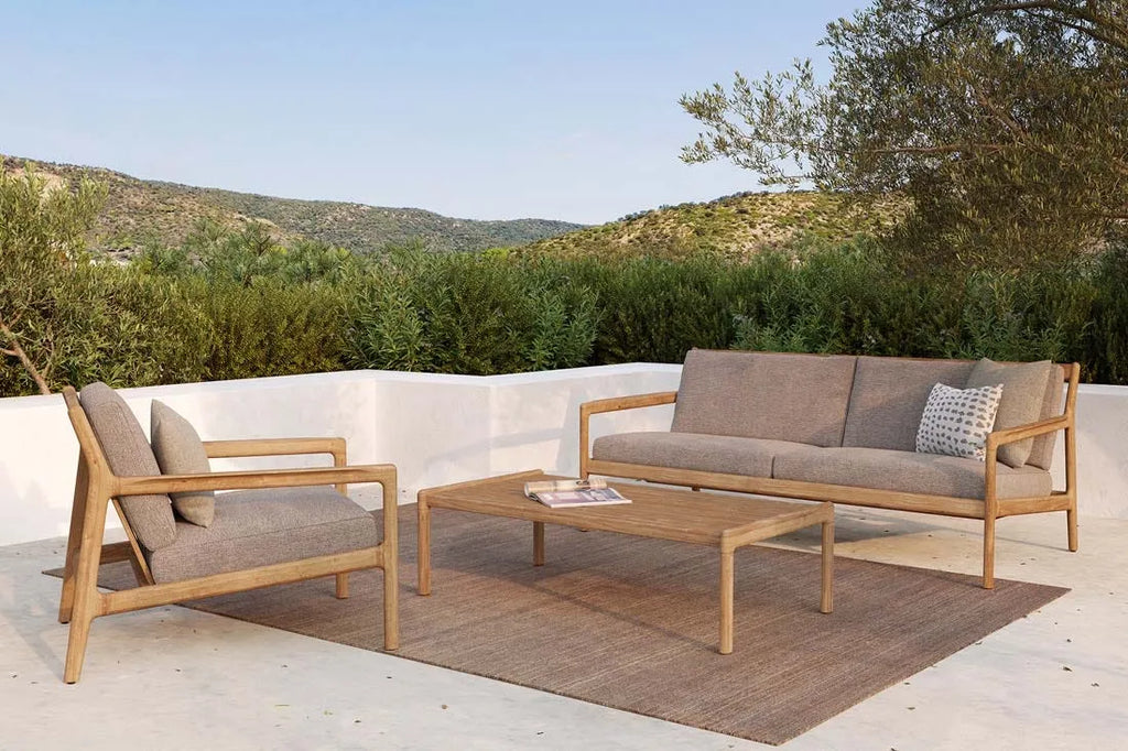 A stylish outdoor area featuring the Harbour Knot outdoor rug in a tawny brown