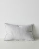 A lumbar cushion with a flange edge and a central seam, made of European linen in a subtle light dove grey. 