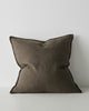 A large, Euro style cushion in dark green with flanged edges, made from soft linen. 