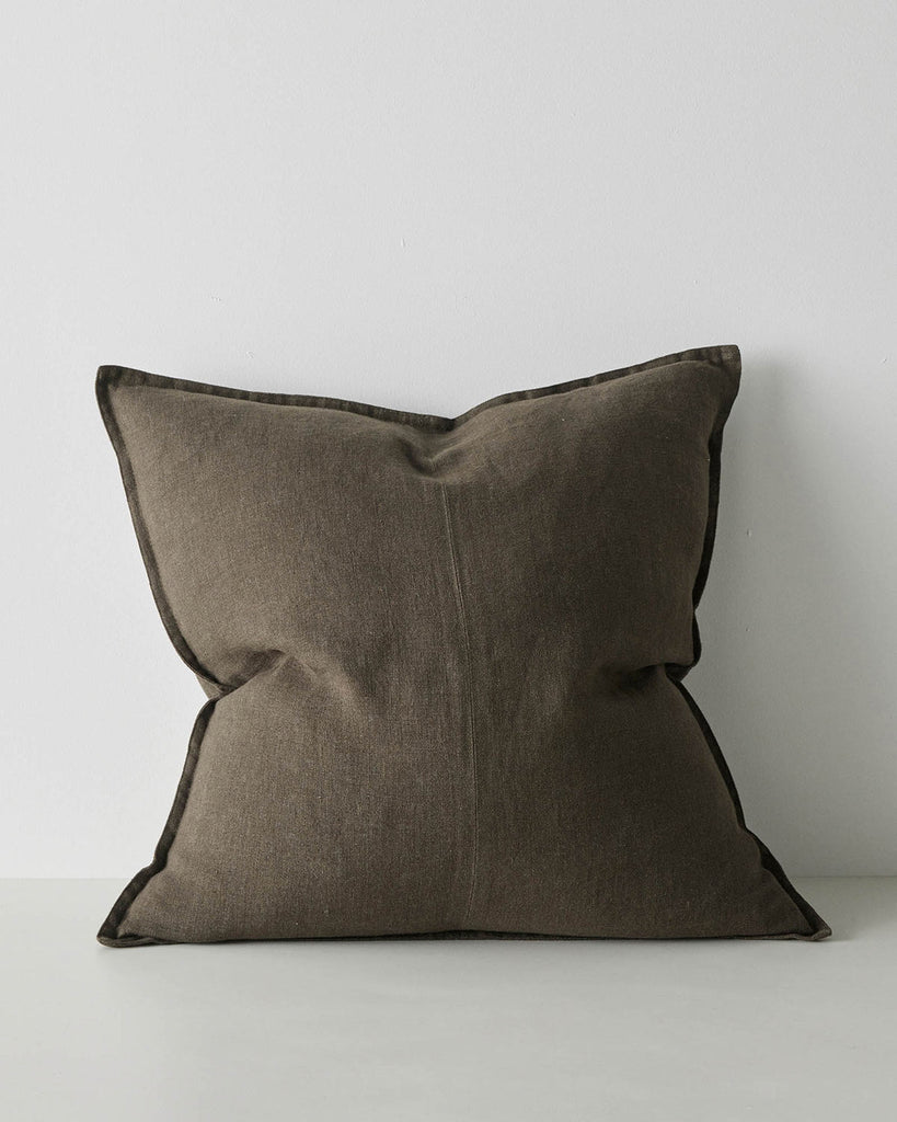 A large, Euro style cushion in dark green with flanged edges, made from soft linen. 