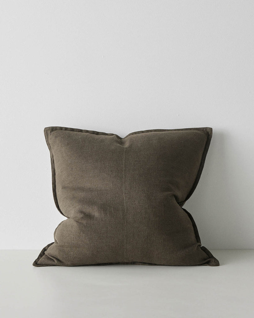 A square linen cushion in an on trend dark  green brown shade with flanged edges and a central seam.