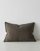 A lumbar cushion in a warm dark green tone made with textural soft European Linen. 