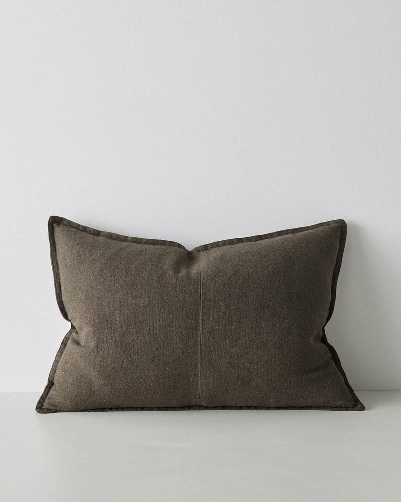 A lumbar cushion in a warm dark green tone made with textural soft European Linen. 