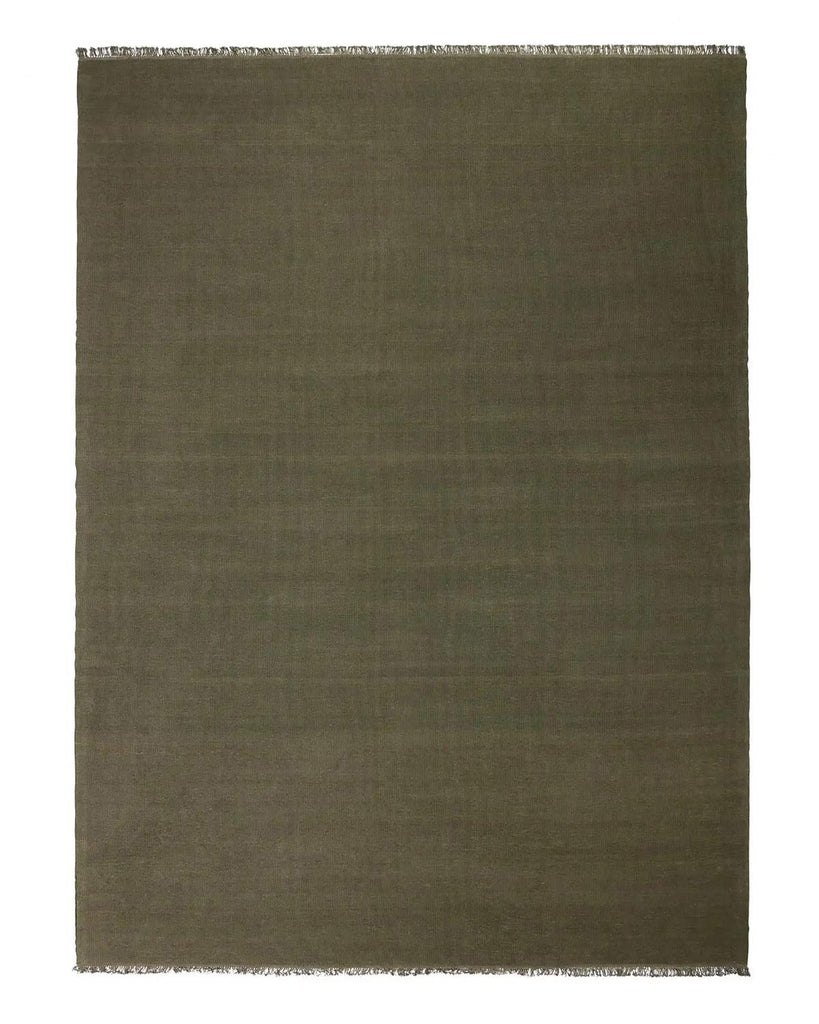 A full image of a 100% linen fibre, handwoven olive green floor rug with fringed edges. 