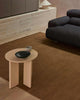 A sitting room with a modern designer coffee table and a warm mid-toned brown floor rug made with 100% linen. 