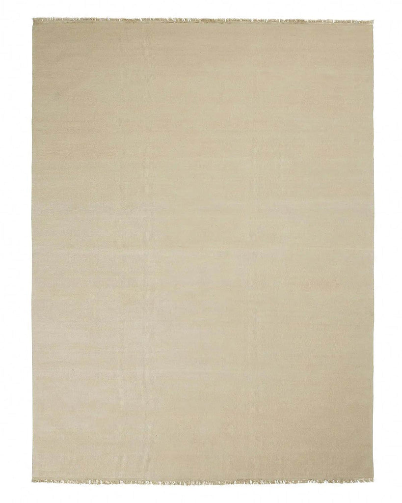 A full image of a handmade cream toned floor rug in 100% linen. 