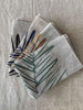 Folded handprinted linen teatowels 'Leaf' by Smitten Textile Designs, on natural oat linen - in several colourways