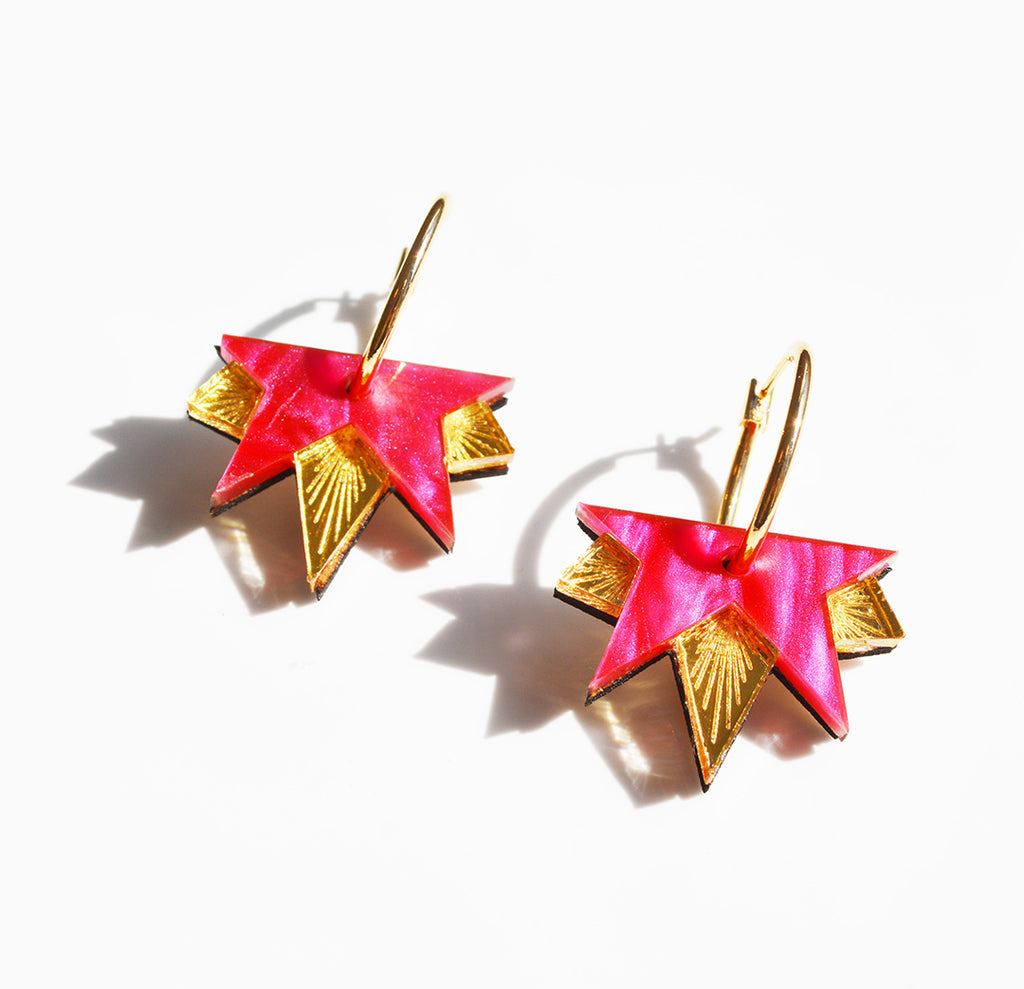 Close up of the Lucky Star acrylic earrings in pink and gold, by Hagen and Co