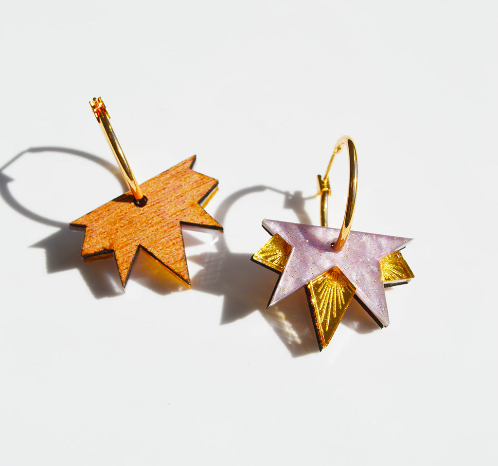 Close up of the Lucky Star acrylic earrings in lilac and gold, by Hagen and Co, showing the back of one