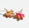 Close up of the Lucky Star acrylic earrings in pink and gold, by Hagen and Co, showing the back of one earring