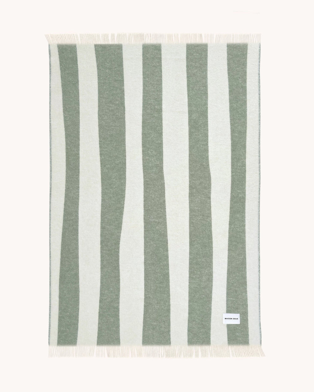 Full view of the Rough Stripe throw blanket by Maison Deux in shade Agave. The stripes are uneven, lending style and whimsy. 