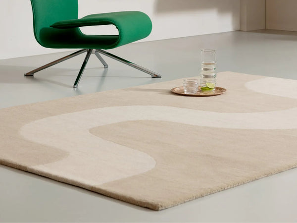 The Marimekko Seireeni wool floor rug in a neutral warm beige colour, seen in a modern living space