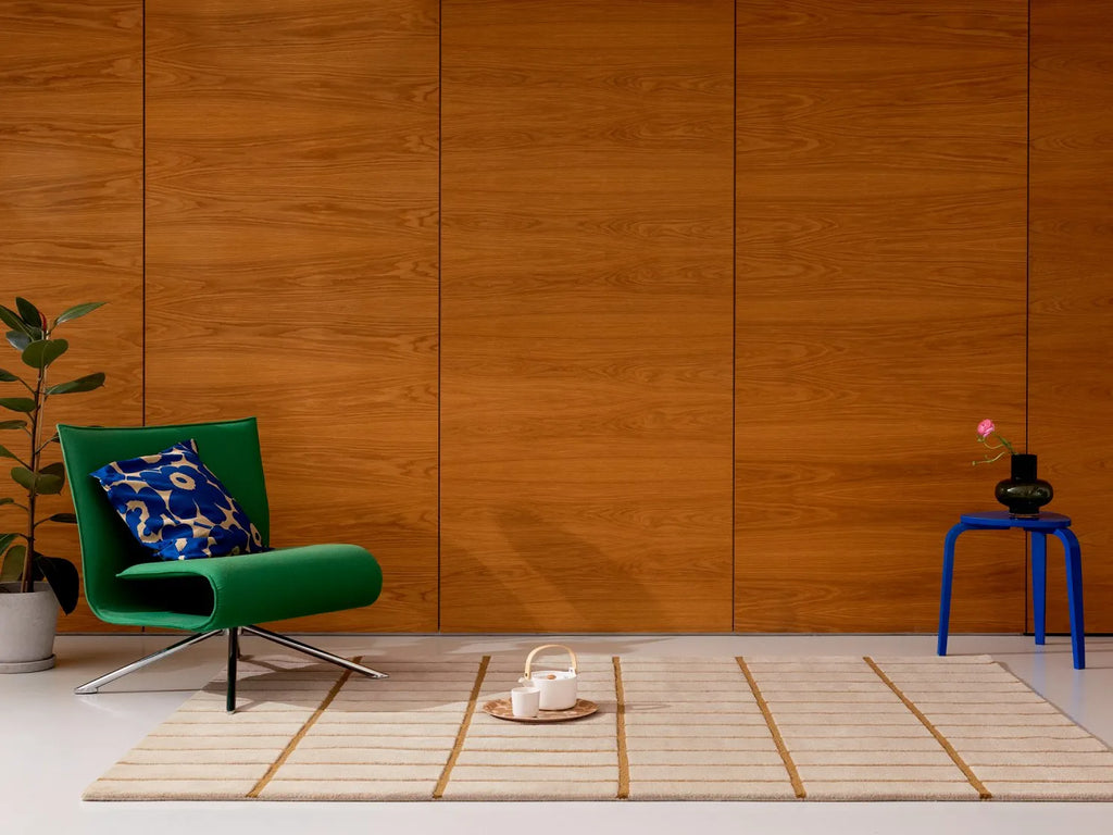 The Marimekko Tilliskivi wool floor rug in bronze yellow, seen in a modern home