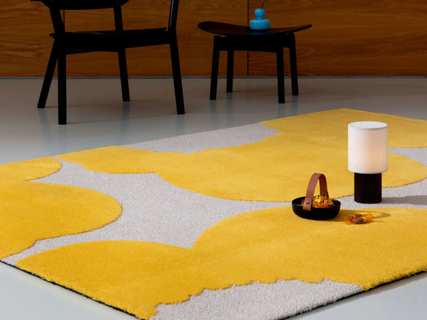 Marimekko Iso Unikko wool rug in yellow, seen in a contemporary space