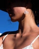 Mumbai dangle earrings worn by a stylish woman wearing a hat