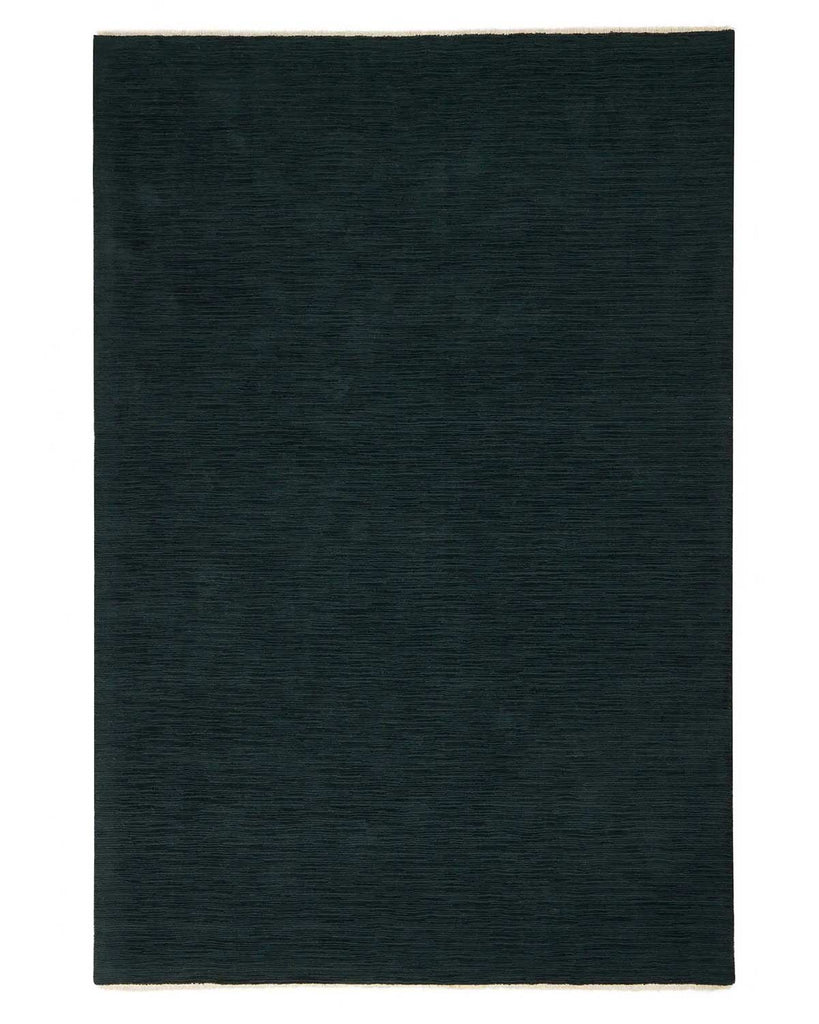 A full image of a deep blue floor rug with light cream fringed edging, in 100% NZ wool. 