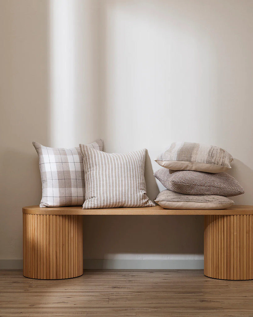 Neutral toned, linen Baya cushions on a timber seat