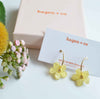 Hagen + Co gift box packaging next to Wildflower earrings  in buttercup yellow