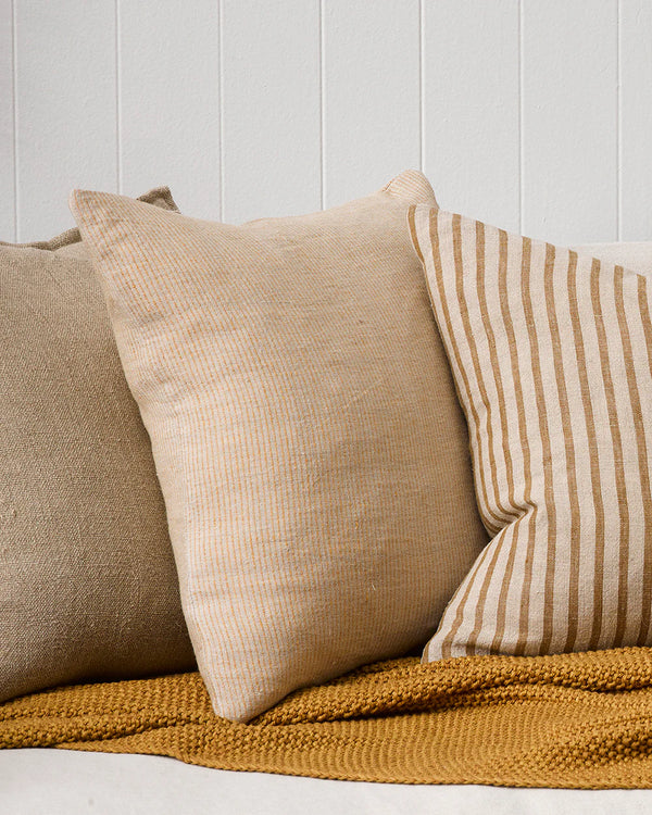 Complementary striped Baya designer cushions  in warm earthy tones