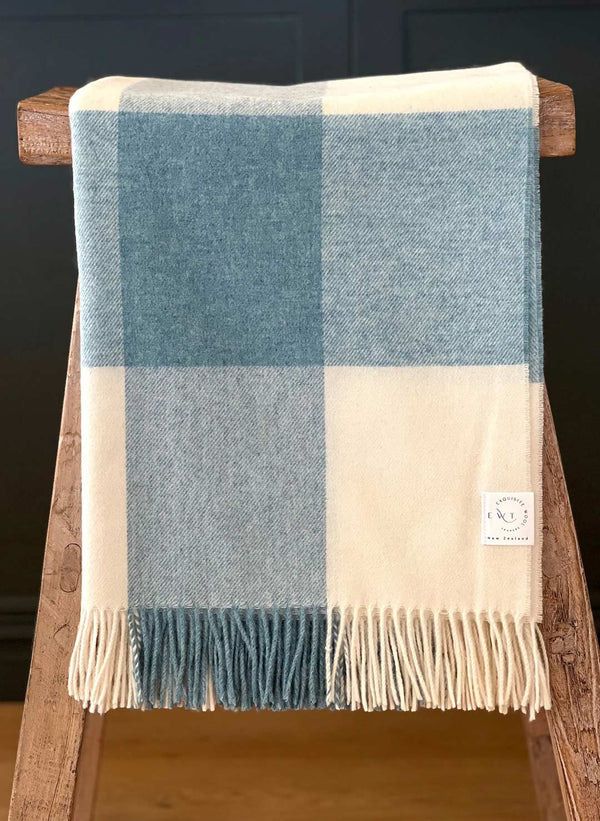 Pure NZ wool throw in cream and blue check plaid, by Exquisite Wool Traders, folded and draped