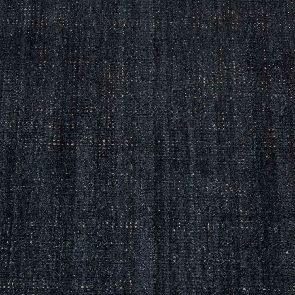 Close up of the weave of a dark blue wool blend floor rug
