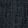 Close up of the weave of a dark blue wool blend floor rug