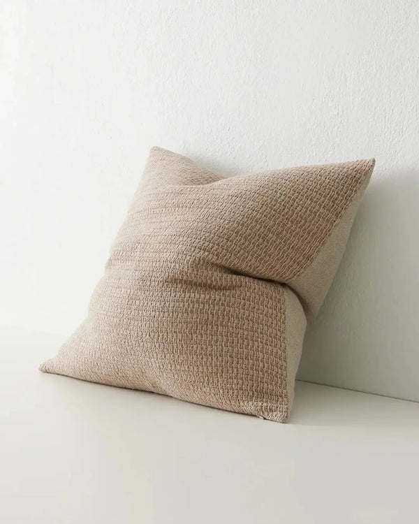 A neutral, textural cushion by Weave Home in a natural linen colour