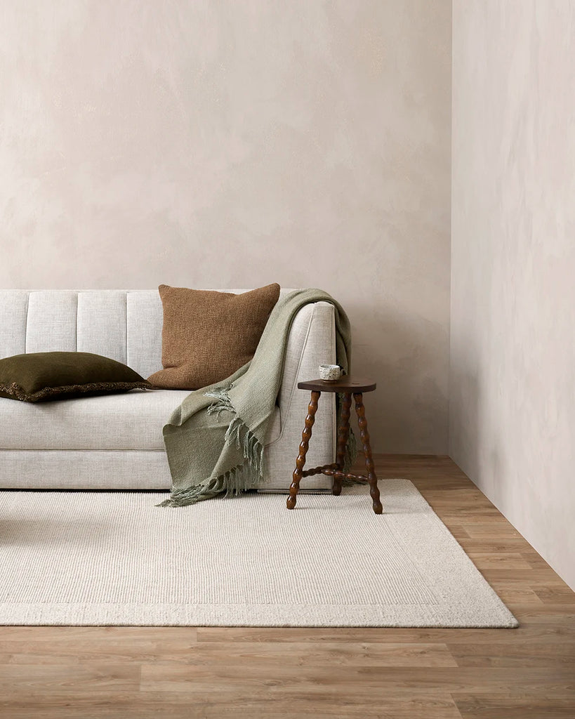 The Baya wool rug 'Vermont' in colour 'Sand, in a contemporary minimalist living room