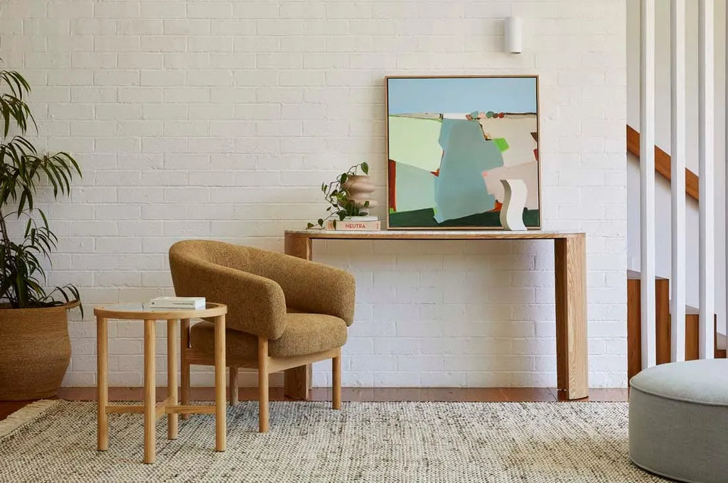 A stylish sitting room with a woven wool and jute rug in soft ivory and olive green by Globe West and Soren Liv NZ