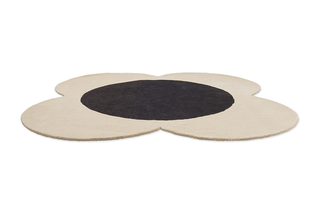 The Orla Kiely Spot Flower Rug in black and ecru seen in perspective