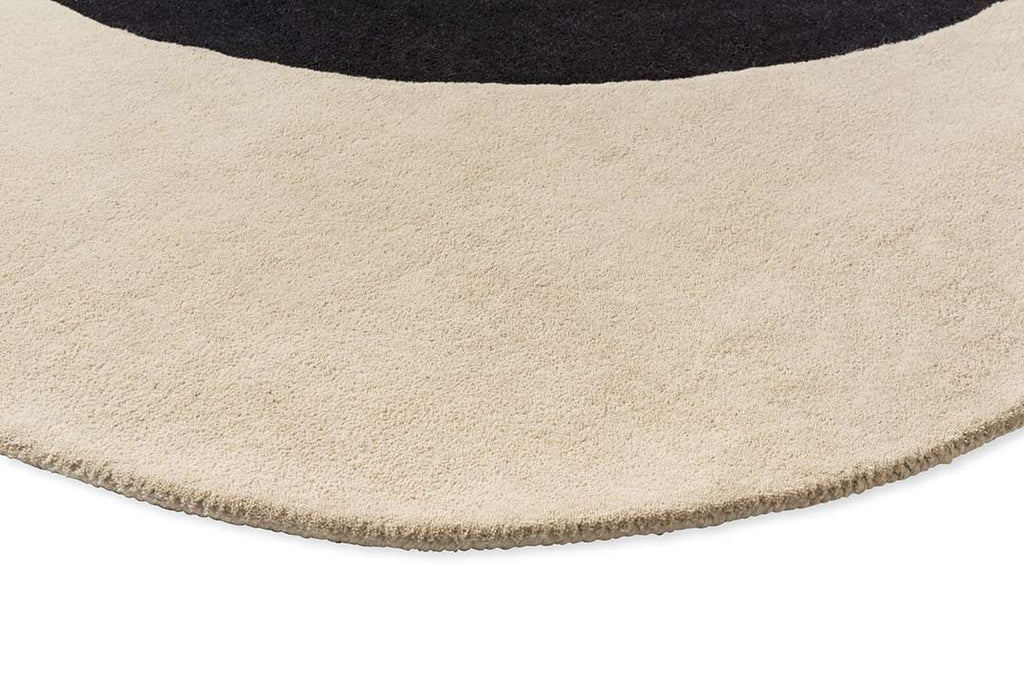 Close up of The Orla Kiely Spot Flower Rug in black and ecru to show the soft creamy beige colour