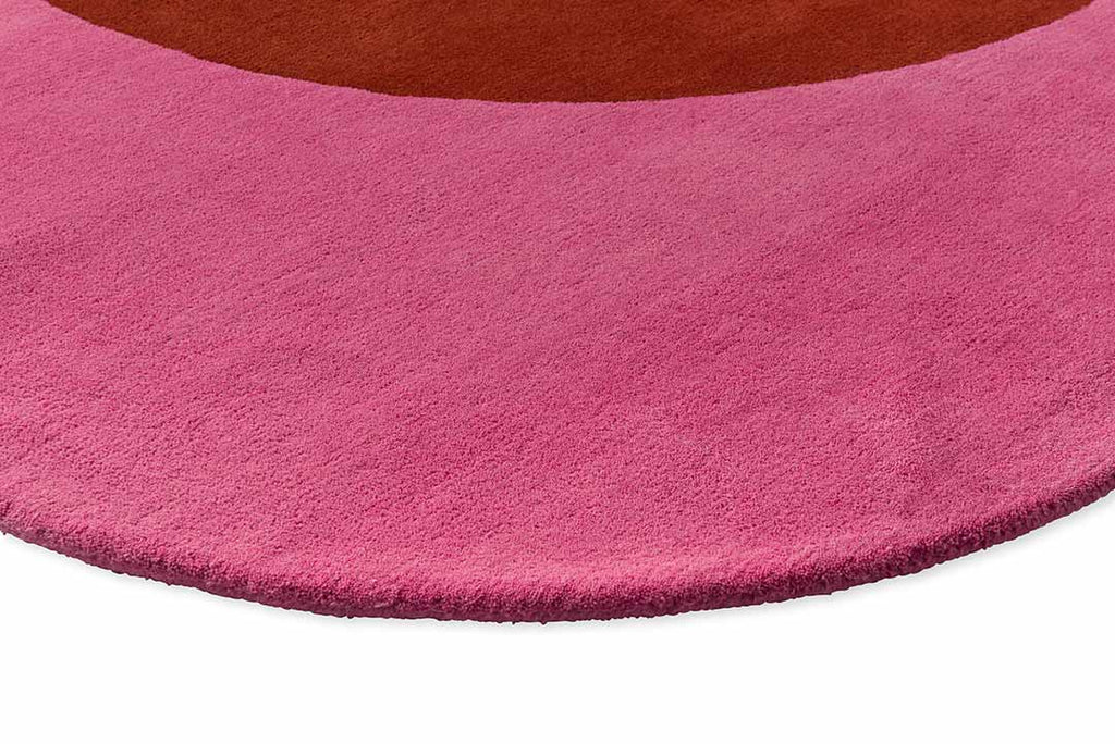 Close up of the red and pink round spot flower floor rug by Orla Kiely showing the pretty raspberry pink tone