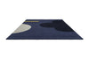 The Orla Kiely Geo Flower floor rug, in colour denim blue, seen in perspective