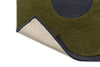 The Orla Kiely Sprig Stem floor rug in colour 'Marine' seen close up with the corner lifted to reveal underneath 