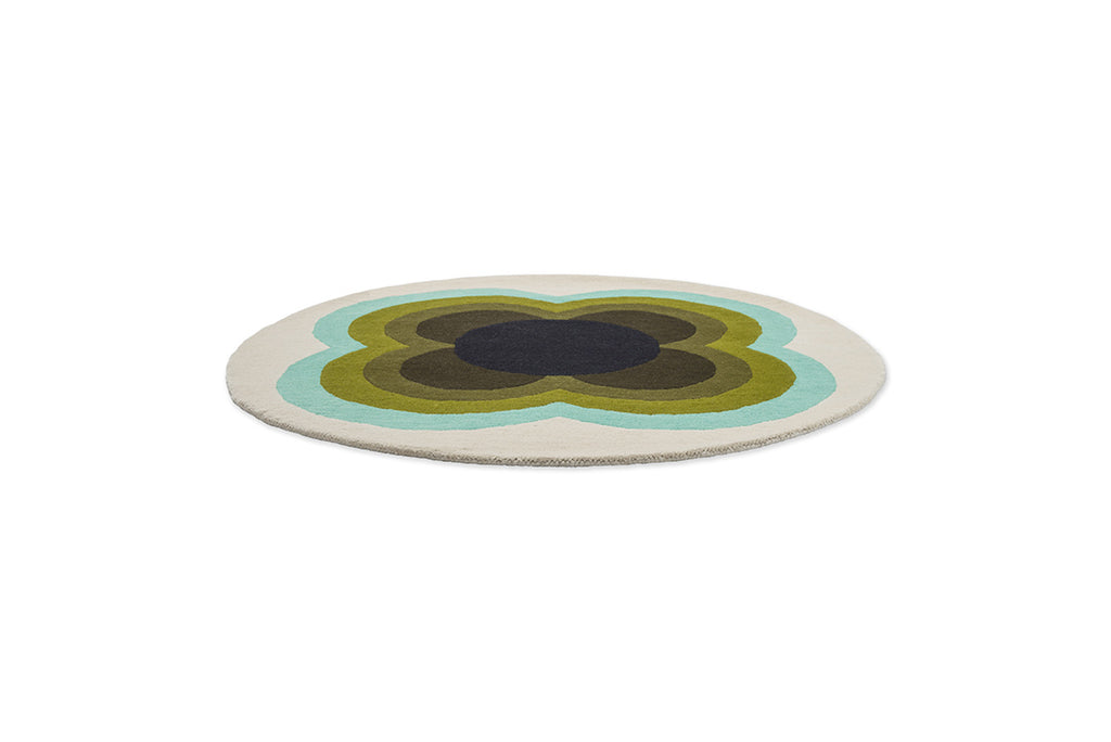 The Orla Kiely round, wool Sunflower rug in olive green tones, full view seen in perspective