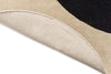 The Orla Kiely Spot Flower Rug in black and ecru with edge folded to reveal underneath